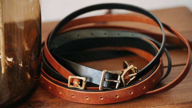 Lọ thủy tinh trống và thắt lưng trên bàn