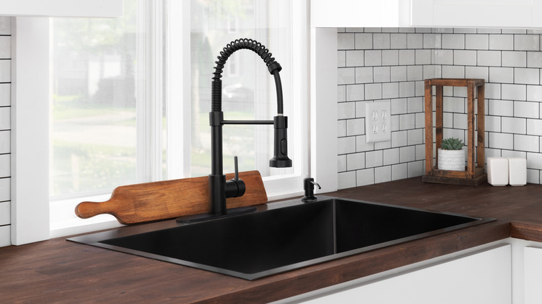 Gạch lát nền tàu điện ngầm màu trắng với vữa tối màu trong nhà bếp hiện đại.