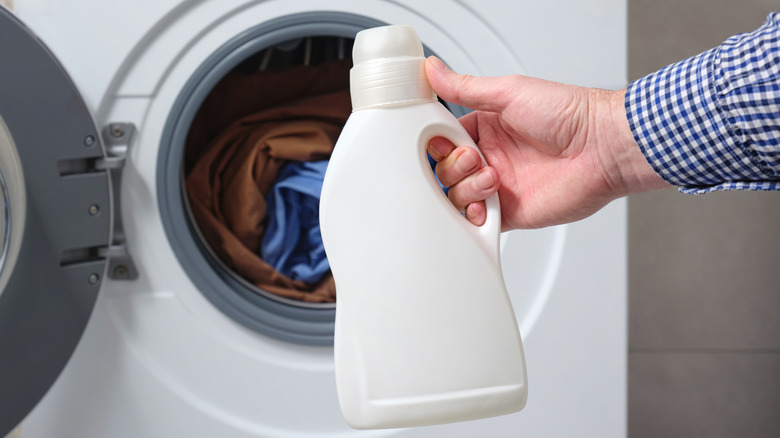 Người đàn ông cầm chai bột giặt