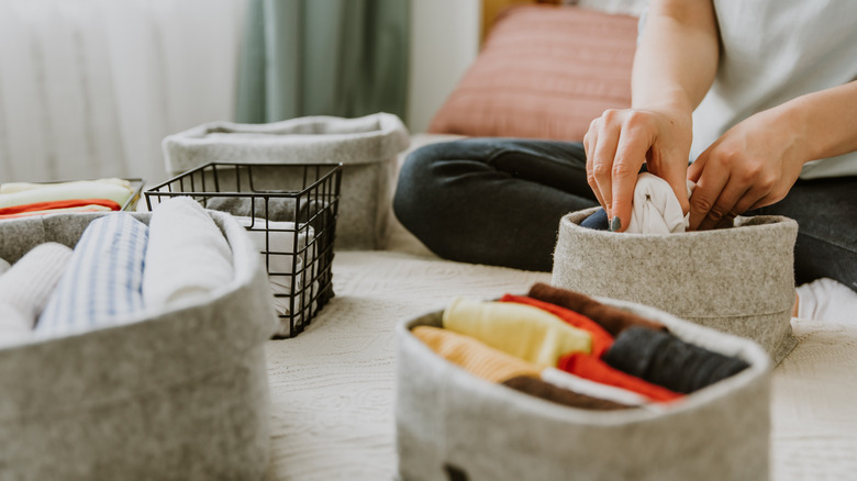 Người sắp xếp các vật phẩm vào các thùng chứa tổ chức nhỏ khác nhau